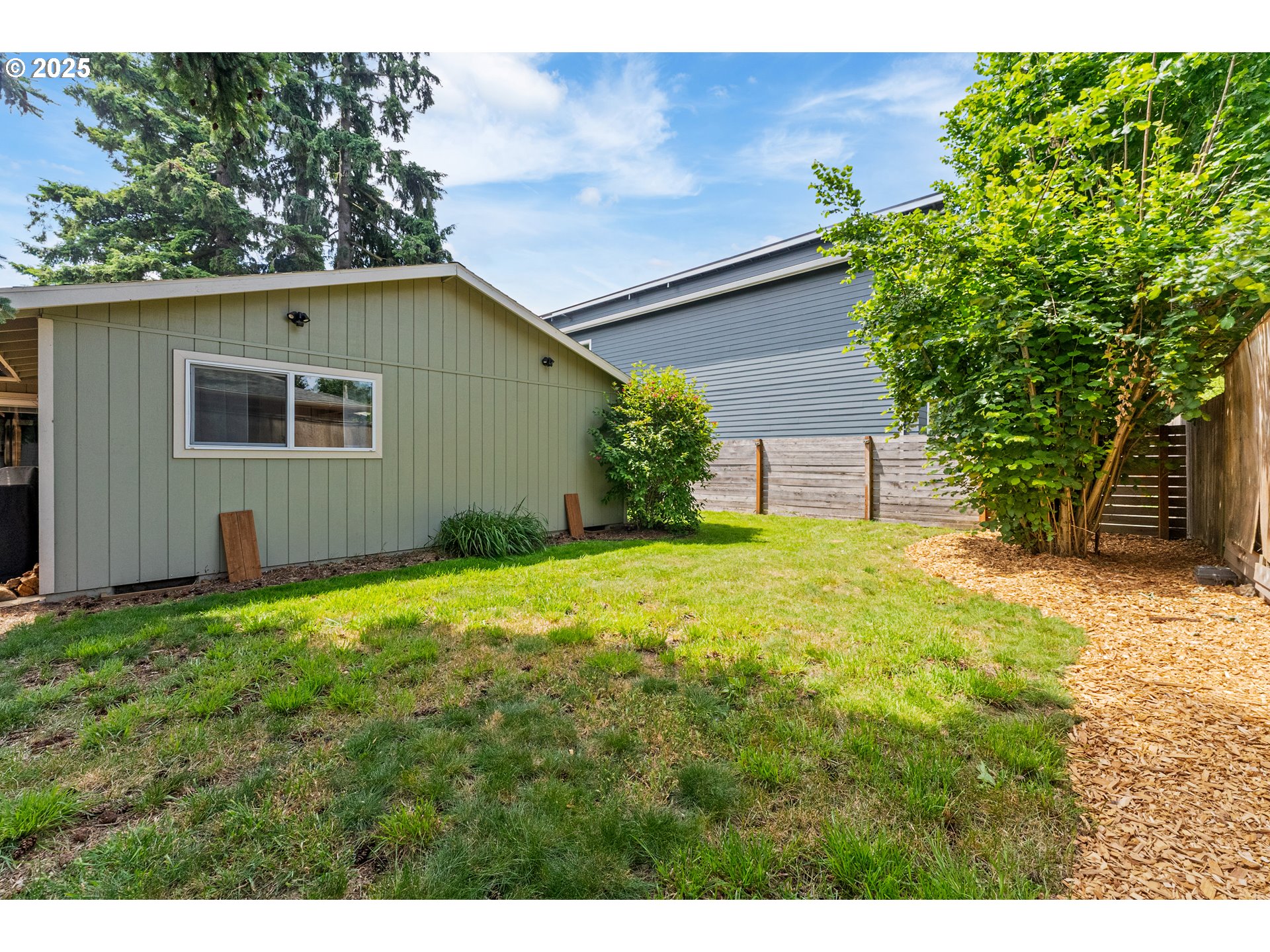 9145 Southeast Oak Street Portland, OR 97216 - Photo 23 of 27 a backyard of a house with plants and large tree