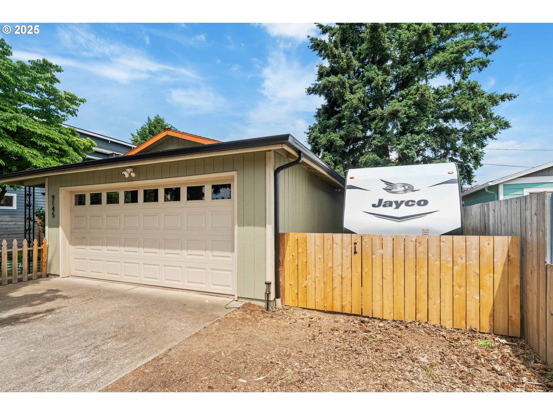 9145 Southeast Oak Street Portland, OR 97216 - Photo 3 of 27 a front view of a house with a garden