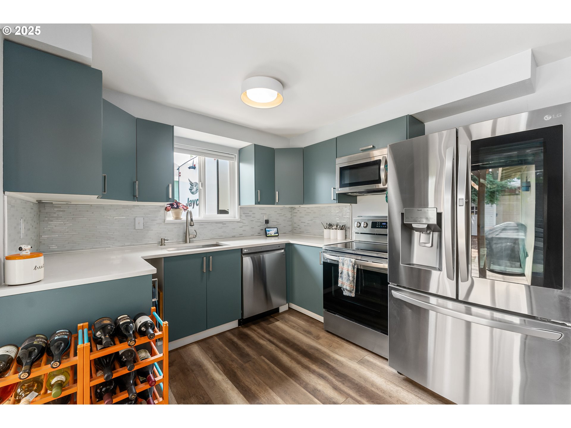 9145 Southeast Oak Street Portland, OR 97216 - Photo 9 of 27 a kitchen with stainless steel appliances granite countertop a sink and cabinets