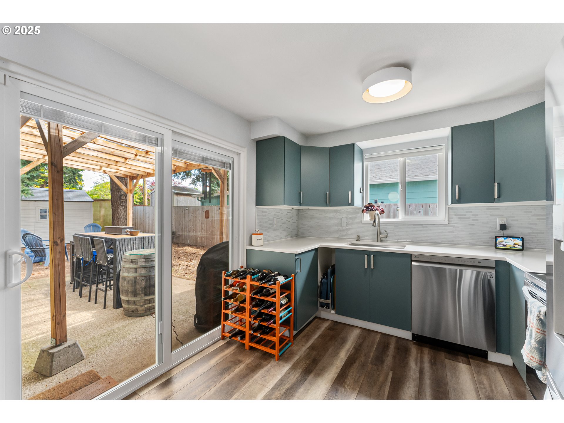 9145 Southeast Oak Street Portland, OR 97216 - Photo 10 of 27 a open kitchen with stainless steel appliances kitchen island granite countertop a sink and cabinets