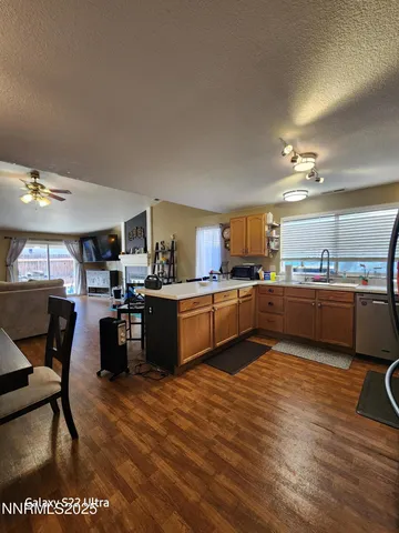 a kitchen with a table chairs sink and cabinets