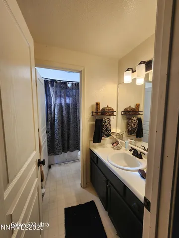 a bathroom with a sink a mirror and a shower