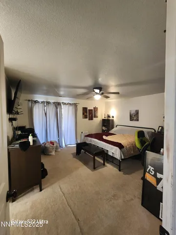 a bedroom with furniture and a window