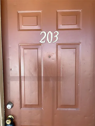 a view of a room with wooden floor cabinet and a ceiling fan