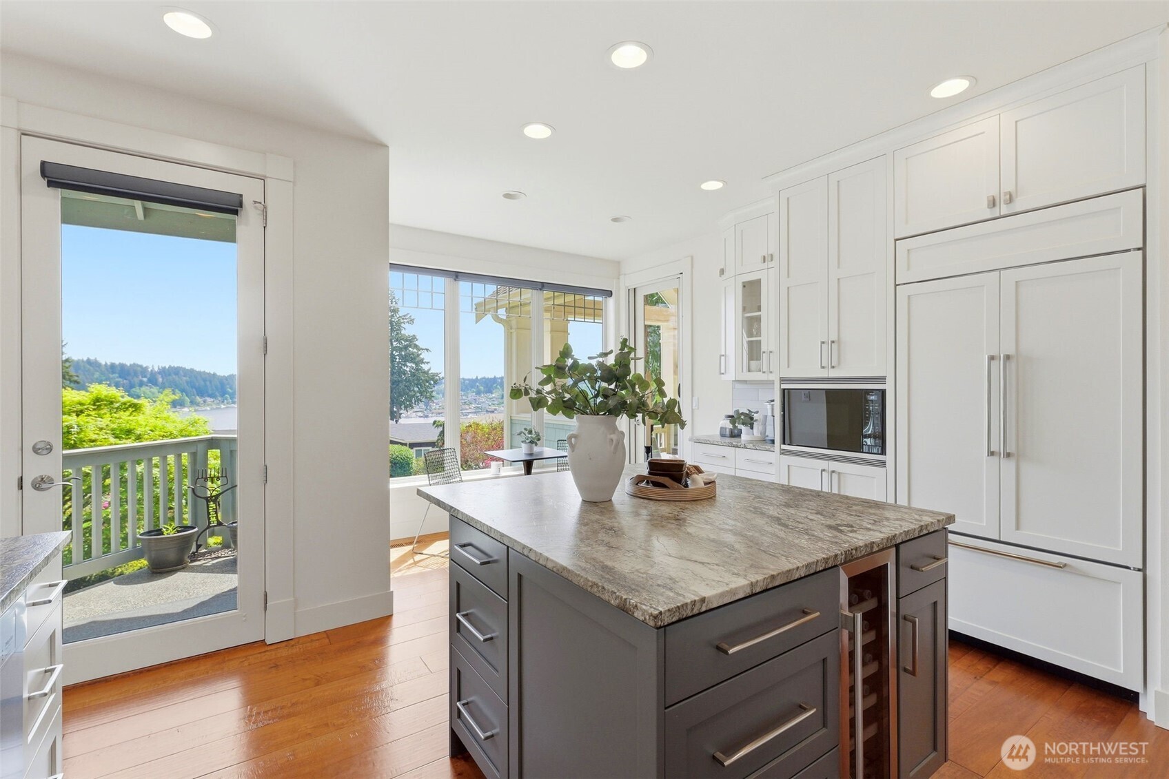 3915 Bay View Lane Gig Harbor, WA 98332 - Photo 13 of 40 a kitchen with granite countertop white cabinets and stainless steel appliances