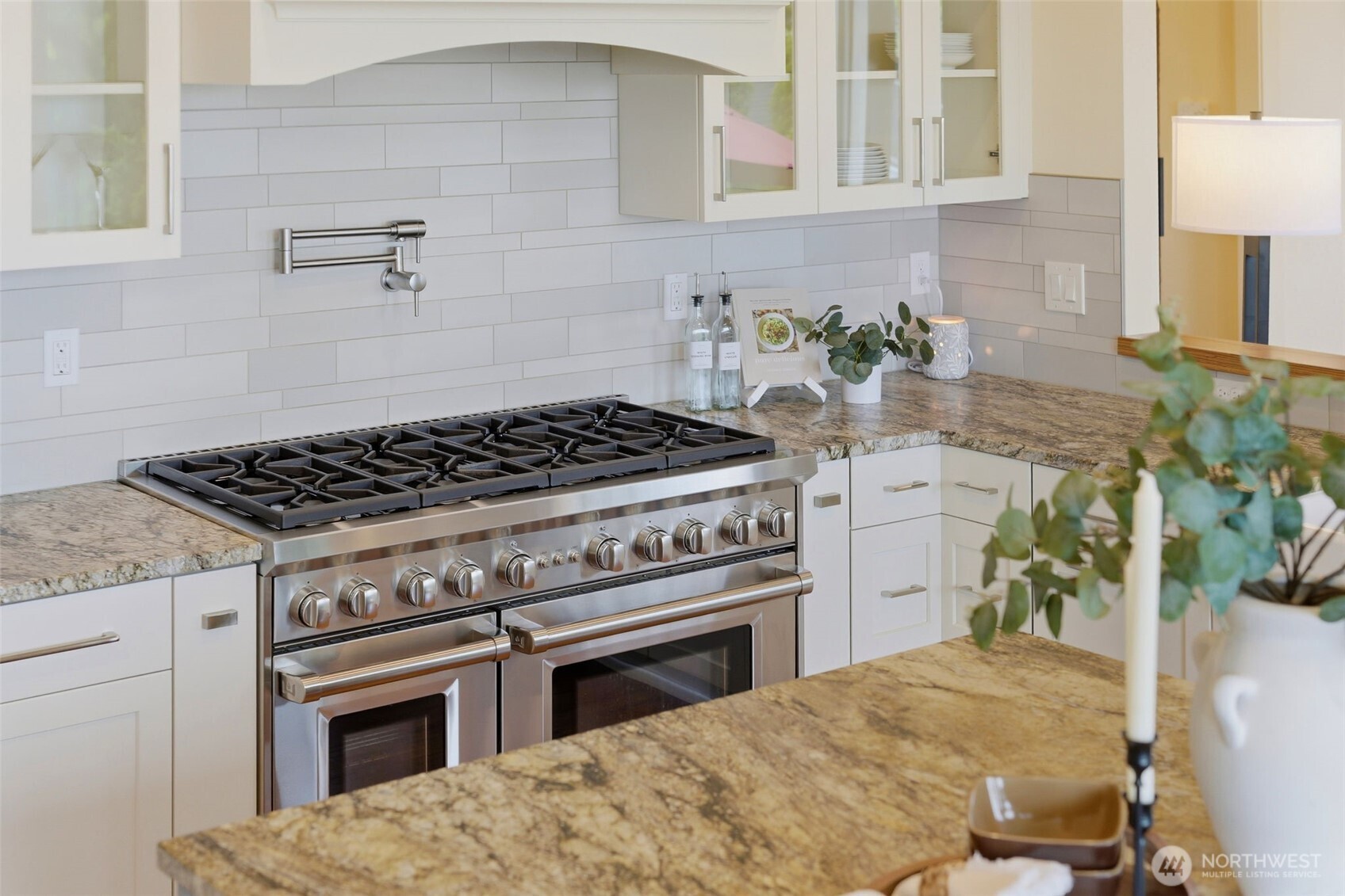3915 Bay View Lane Gig Harbor, WA 98332 - Photo 15 of 40 a kitchen with a stove and white cabinets