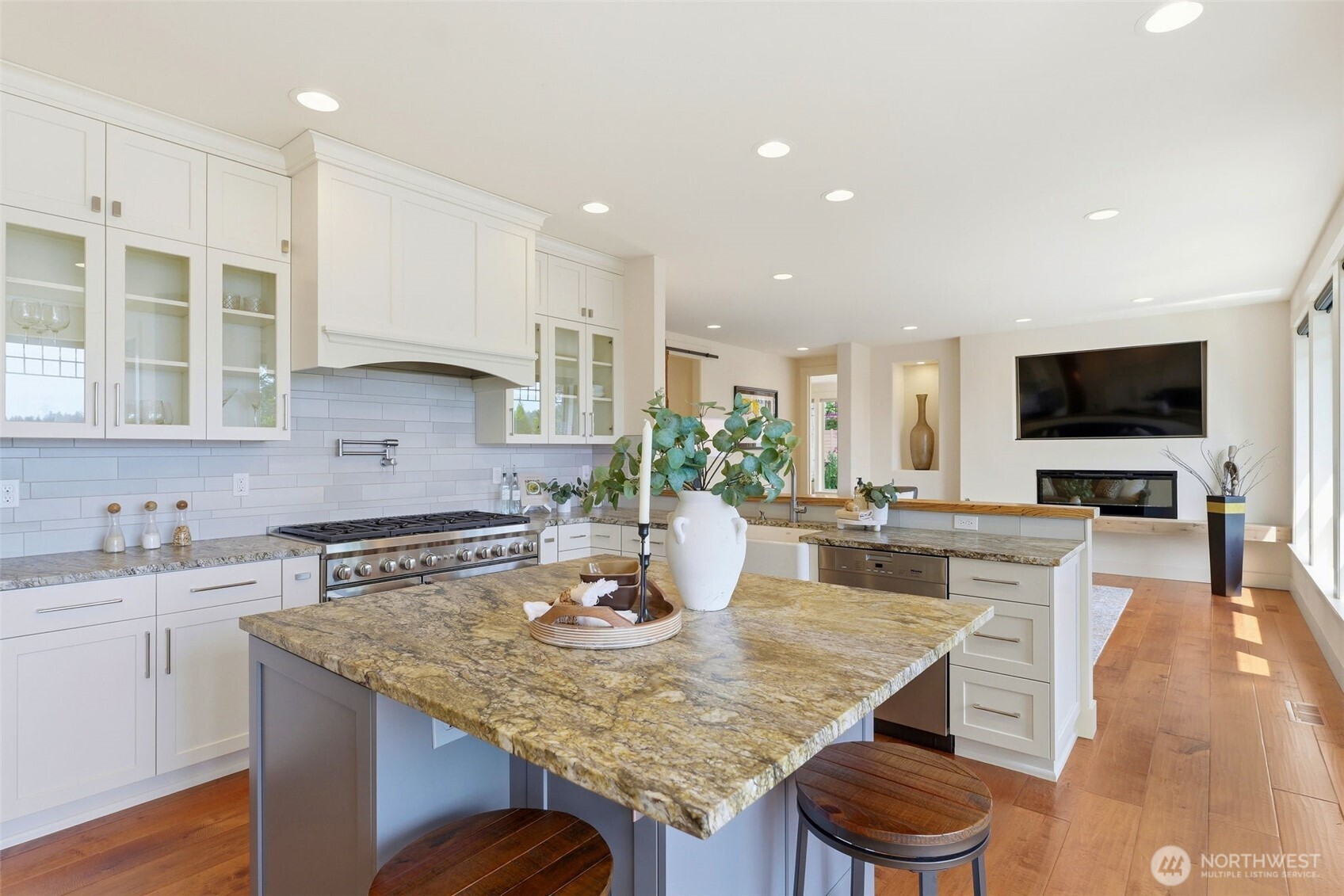 3915 Bay View Lane Gig Harbor, WA 98332 - Photo 16 of 40 a kitchen with granite countertop a stove a sink a dining table and chairs