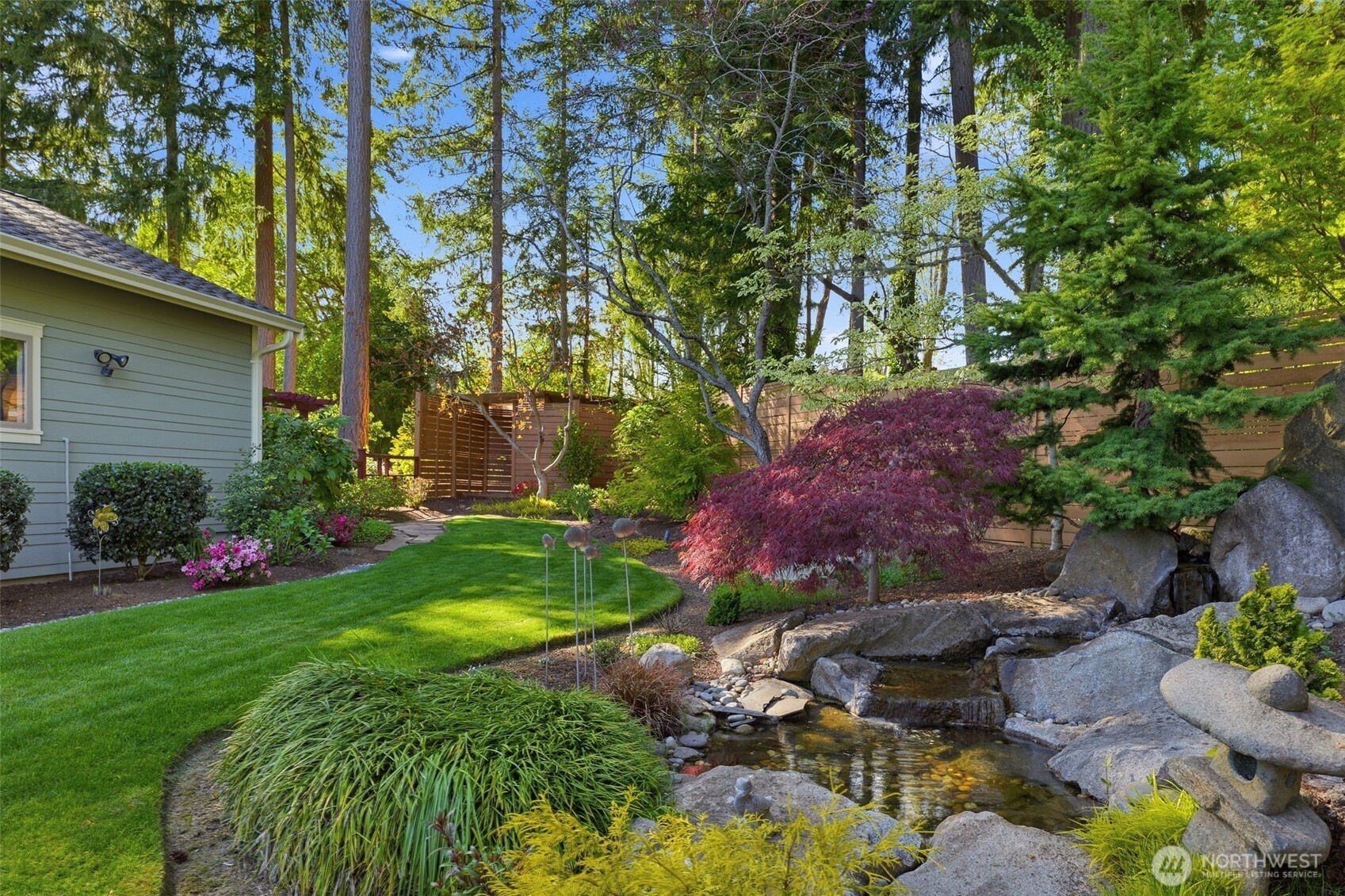 3915 Bay View Lane Gig Harbor, WA 98332 - Photo 28 of 40 a view of a garden with plants and large trees