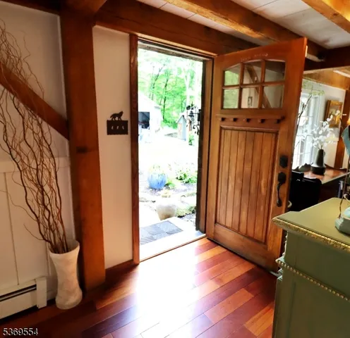 a view of a hallway with dining area and glass door