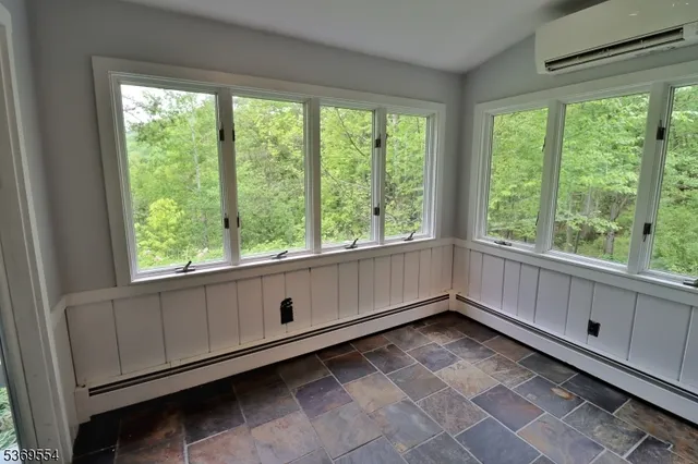 a living room with fireplace furniture and a large window