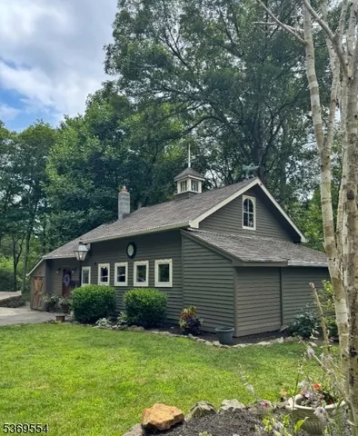 a front view of a house with yard and green space