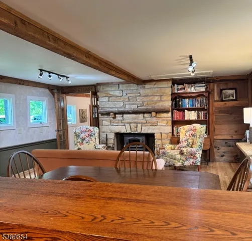 a living room with fireplace furniture and a wooden floor