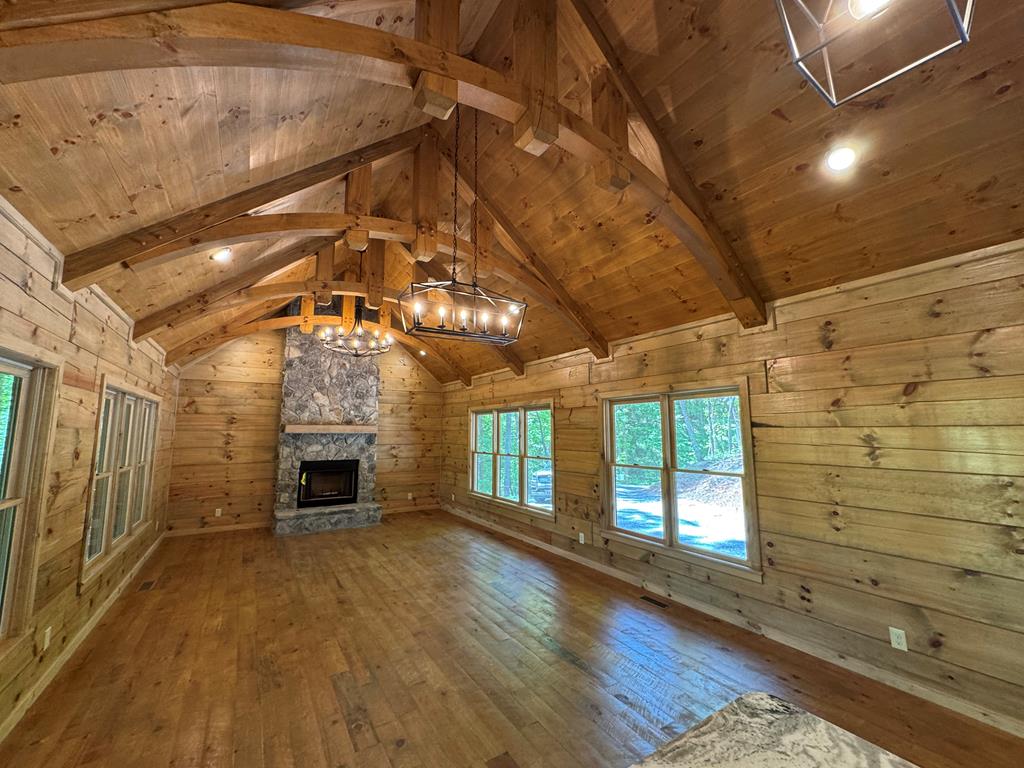 85 Moreland Trail Blue Ridge, GA 30513 - Photo 42 of 56 a view of empty room with wooden floor and fireplace