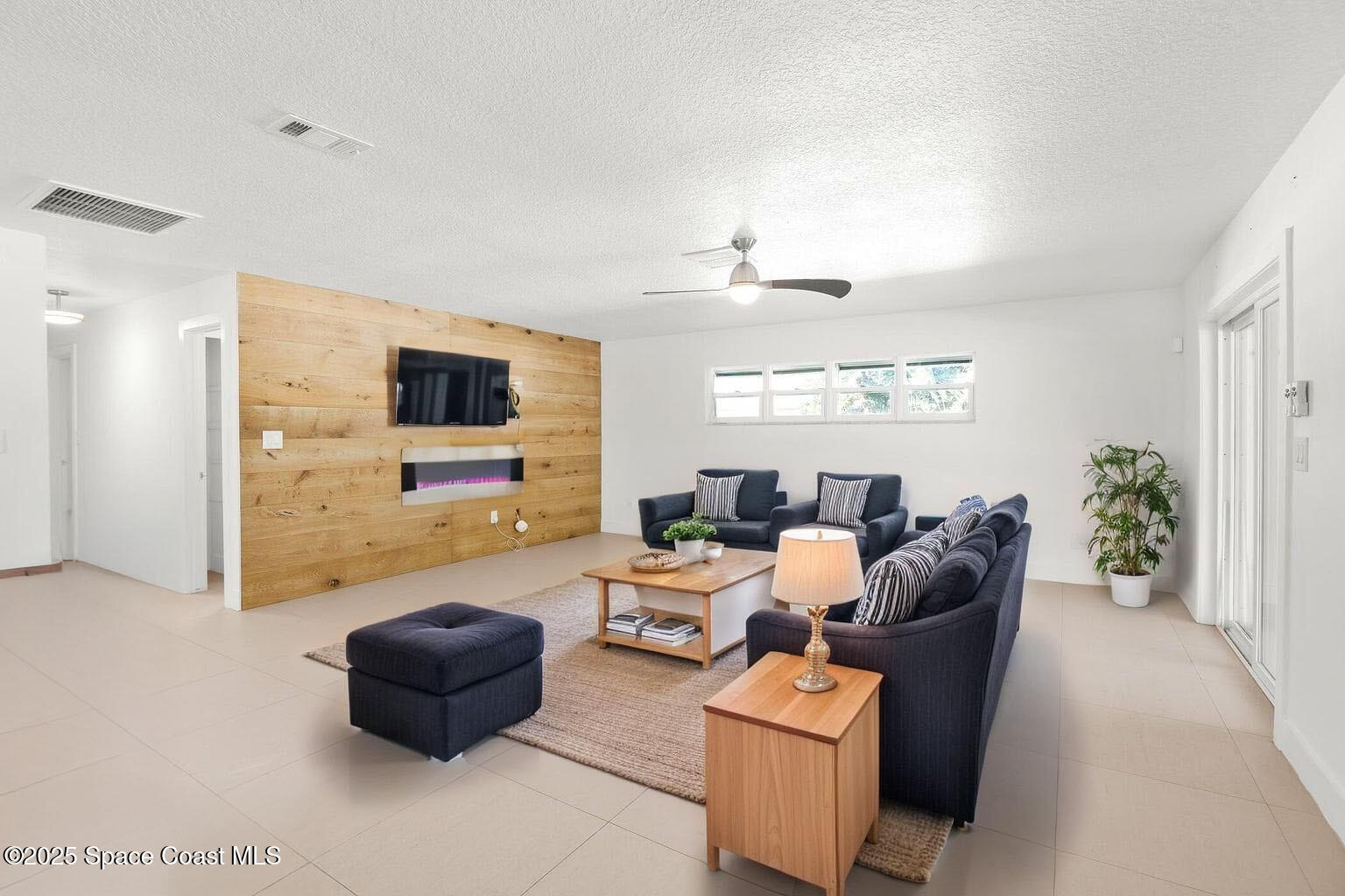 360 East Riviera Boulevard Indialantic, FL 32903 - Photo 11 of 26 a living room with furniture and a flat screen tv