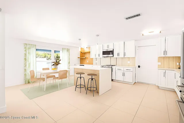a kitchen with stainless steel appliances and white cabinets