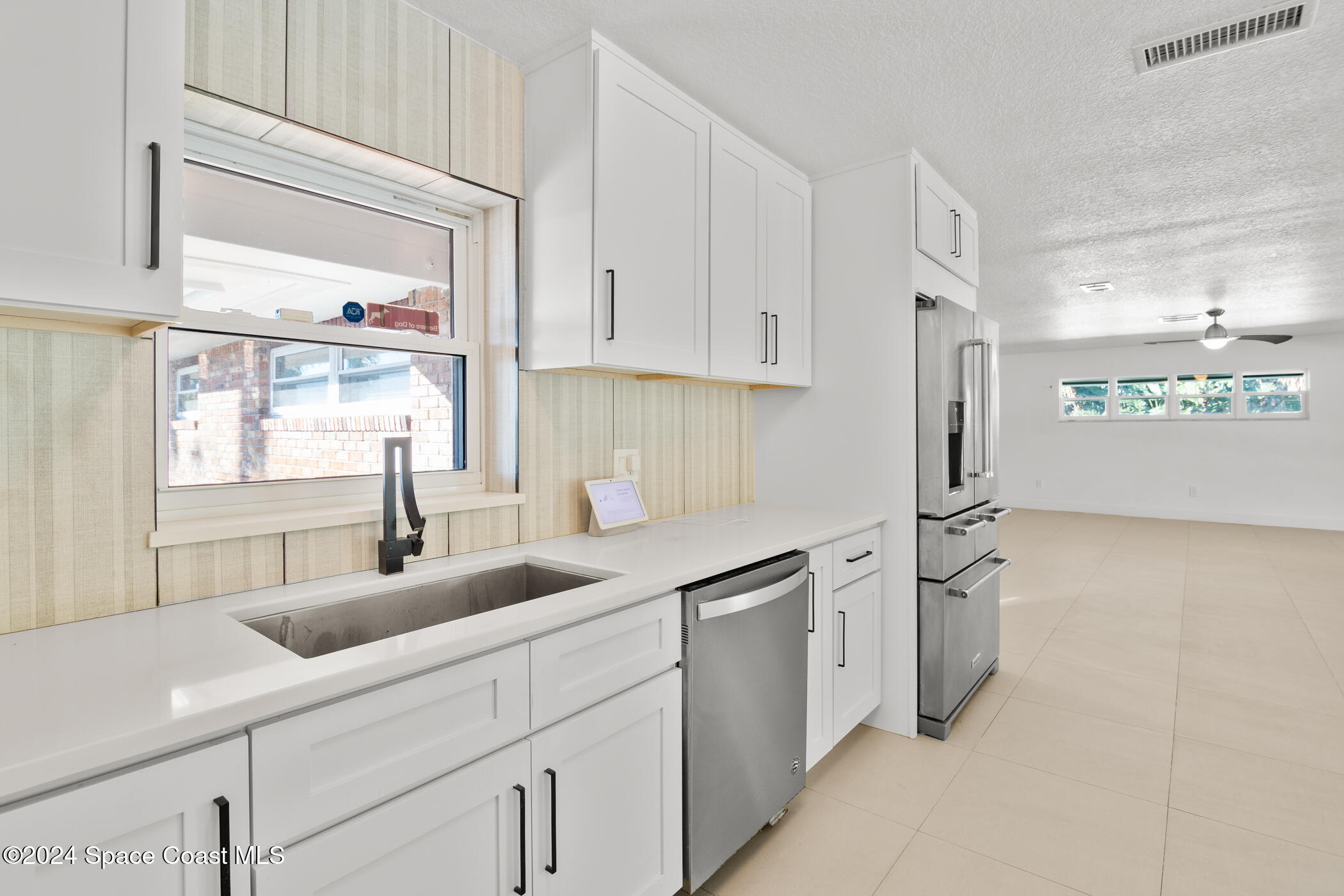 360 East Riviera Boulevard Indialantic, FL 32903 - Photo 8 of 26 a kitchen with stainless steel appliances a sink stove and cabinets