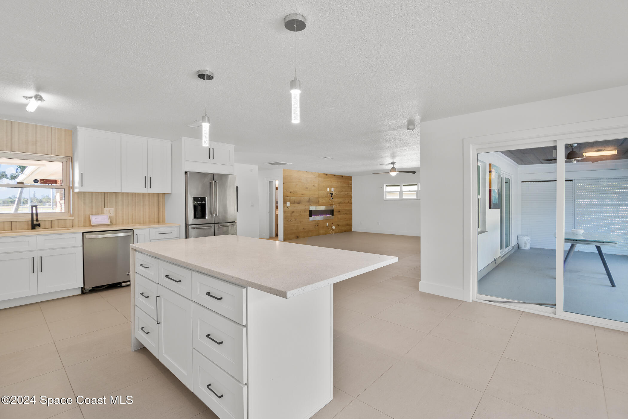 360 East Riviera Boulevard Indialantic, FL 32903 - Photo 9 of 26 a large kitchen with kitchen island a sink stainless steel appliances and cabinets