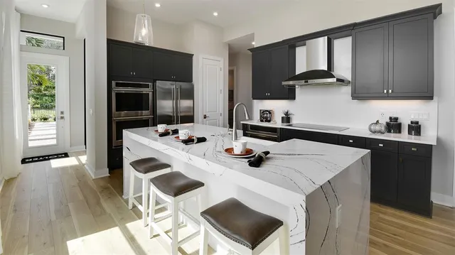 a kitchen with a sink a microwave and cabinets