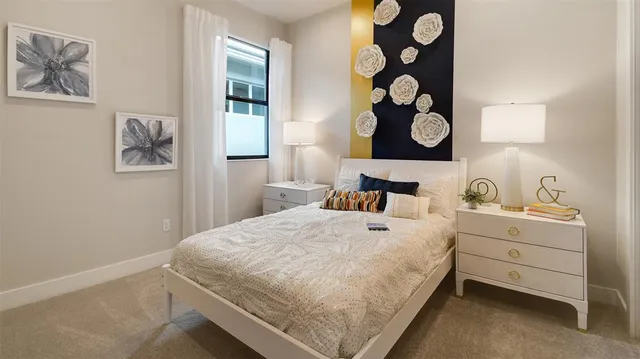 a bedroom with a bed and a painting on the wall