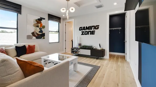 a living room with furniture and wooden floor