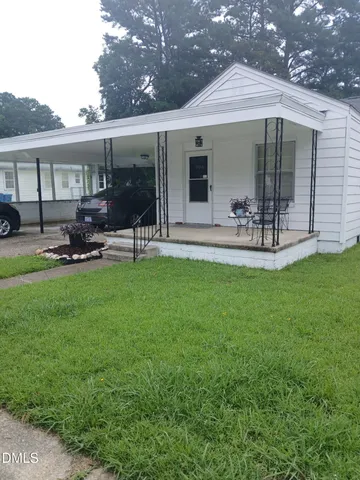 a view of a house with backyard porch and sitting area
