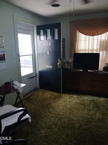 a living room with furniture rug and a window