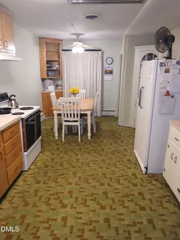 a room with furniture a window and stainless steel appliances