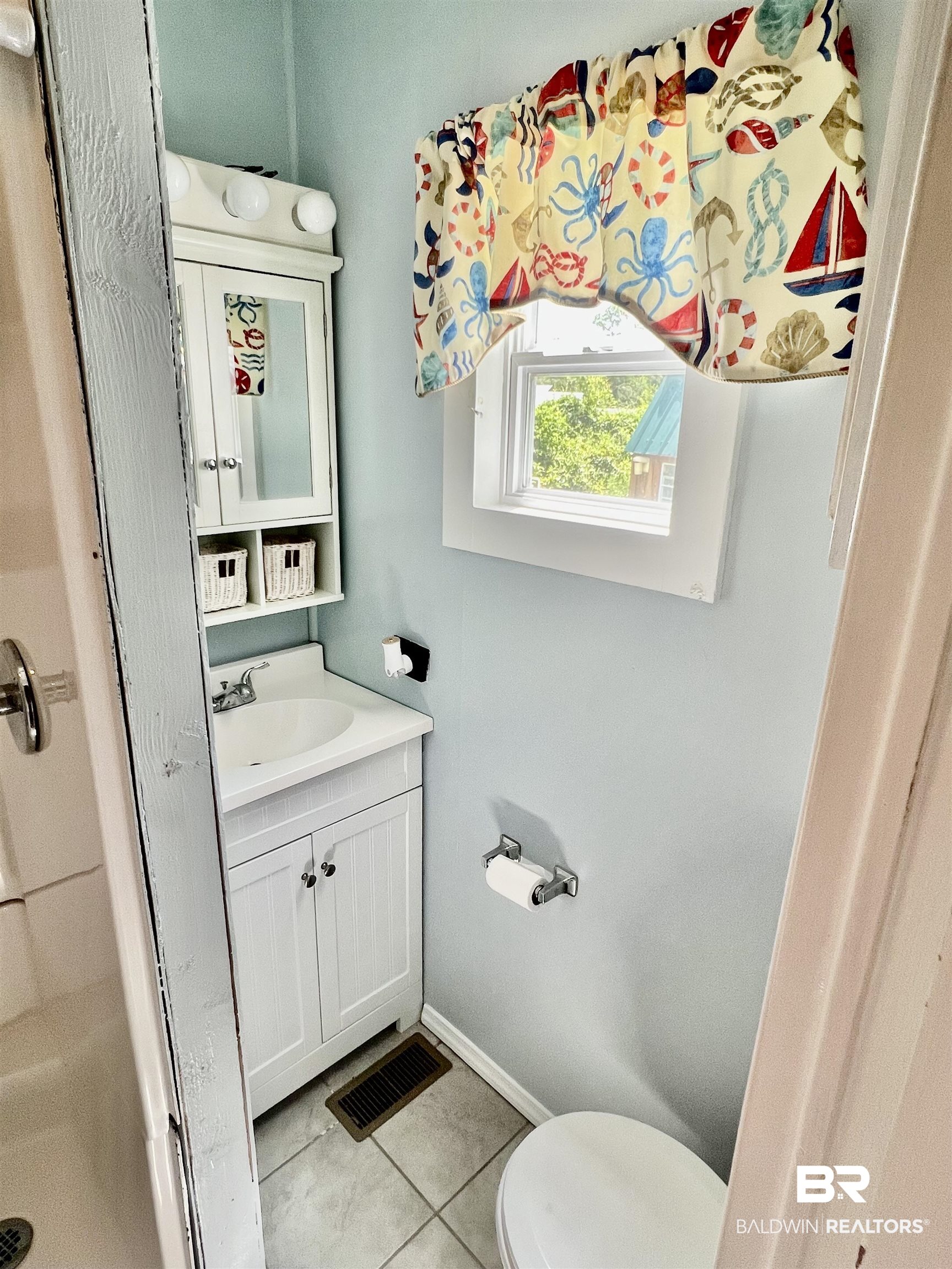 662 Escambia Loop Lillian, AL 36549 - Photo 16 of 26 Bathroom with vanity, tile patterned flooring, and toilet