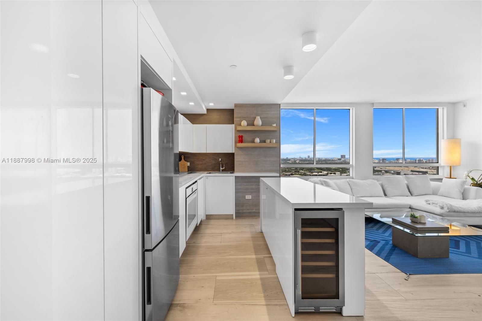 1330 West Avenue, Unit 3407 Miami Beach, FL 33139 - Photo 11 of 42 a kitchen with stainless steel appliances kitchen island granite countertop a refrigerator and a stove