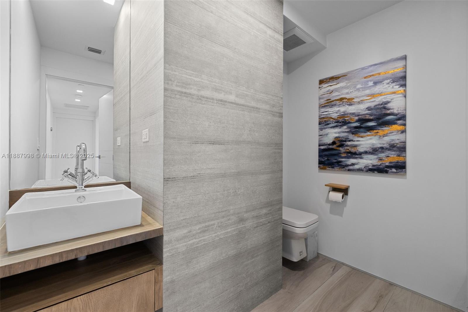 1330 West Avenue, Unit 3407 Miami Beach, FL 33139 - Photo 16 of 42 a bathroom with a toilet sink and mirror