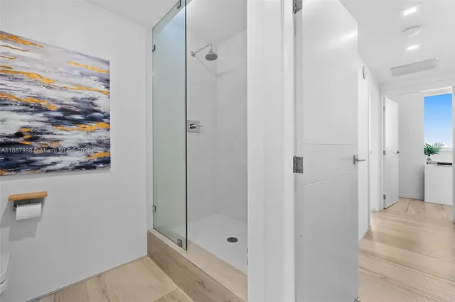 a bathroom with a shower and a sink