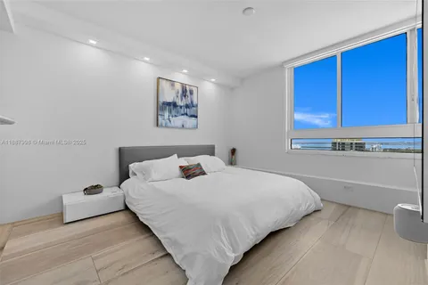 a bedroom with a bed and a night stand