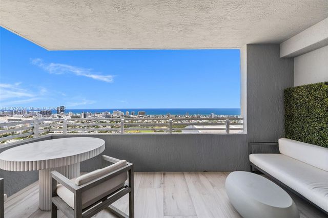 a view of a dining room with furniture a rug and wooden floor