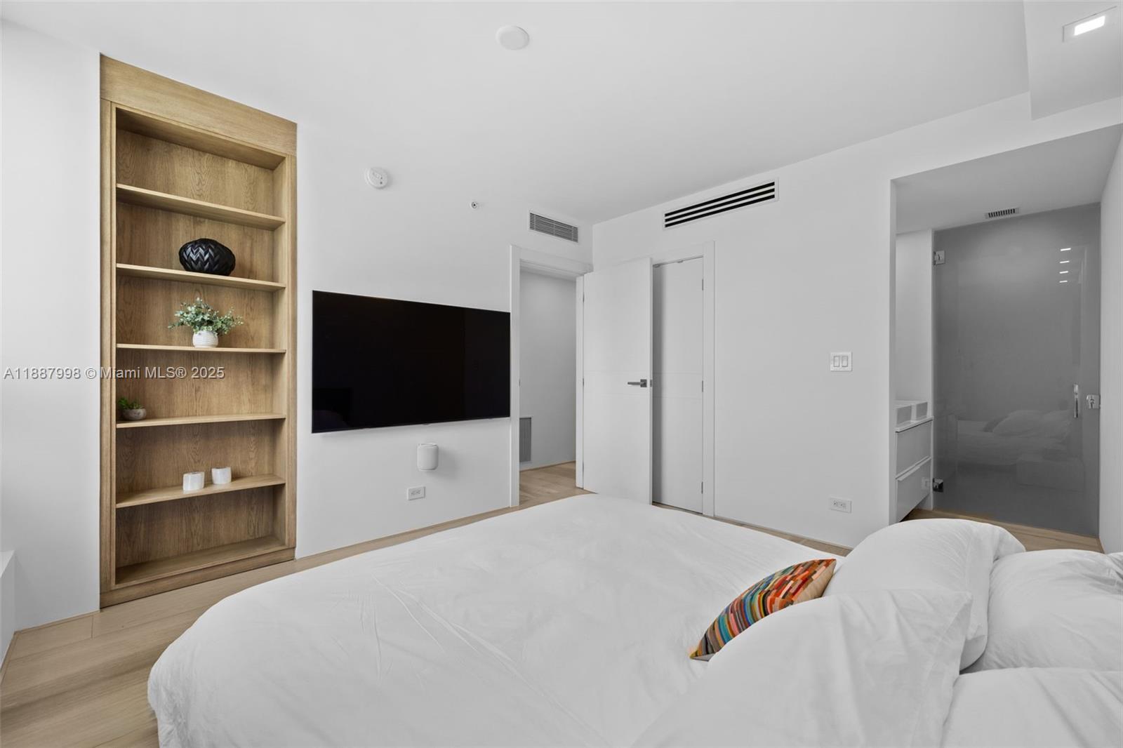 1330 West Avenue, Unit 3407 Miami Beach, FL 33139 - Photo 21 of 42 a bedroom with a bed and a flat screen tv
