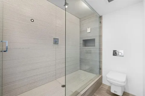 a bathroom with a shower and a toilet
