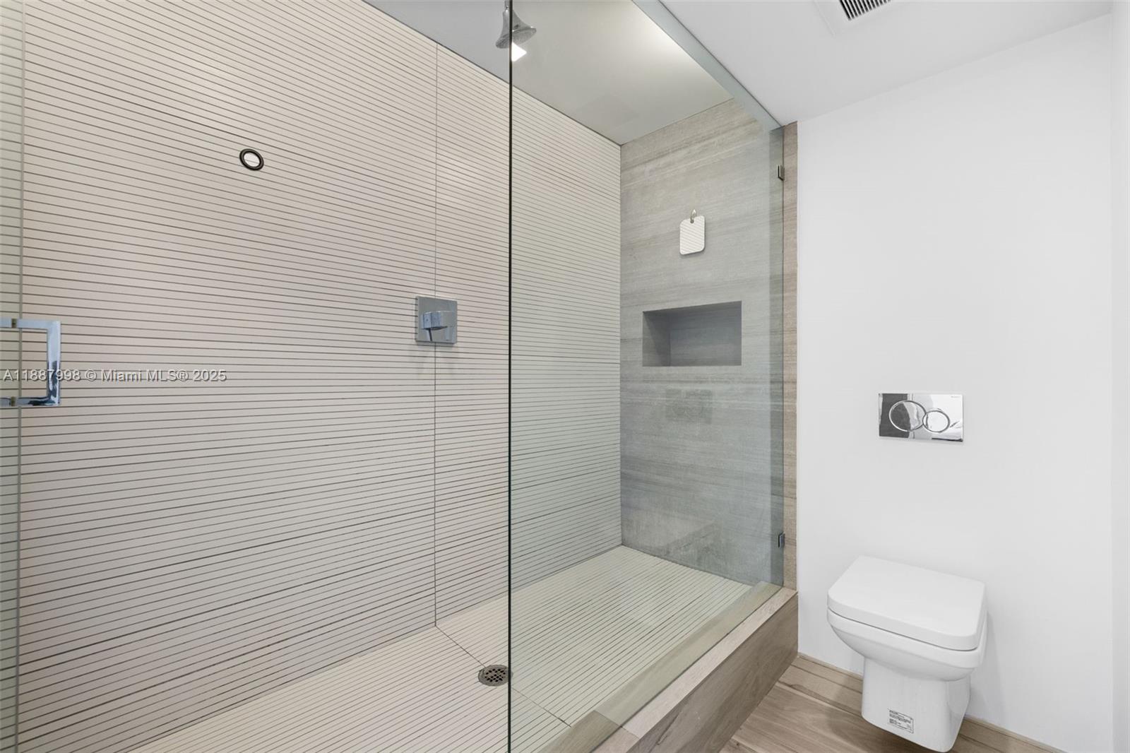 1330 West Avenue, Unit 3407 Miami Beach, FL 33139 - Photo 24 of 42 a bathroom with a shower and a toilet