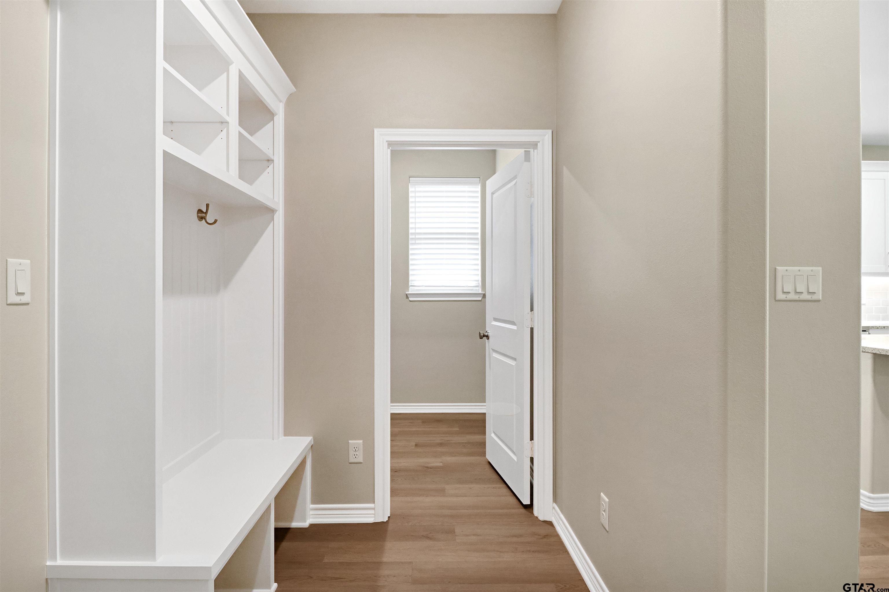 3053 Guinn Farms Road Tyler, TX 75707 - Photo 14 of 32 a view of a hallway with wooden floor and closet