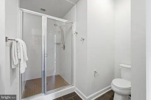 a bathroom with a shower and toilet