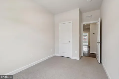 a view of an empty room and closet