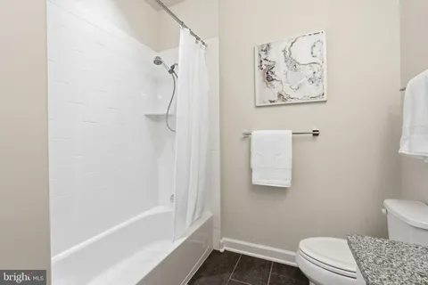 a bathroom with a toilet and shower