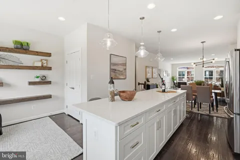 a kitchen with counter top space and wooden floor
