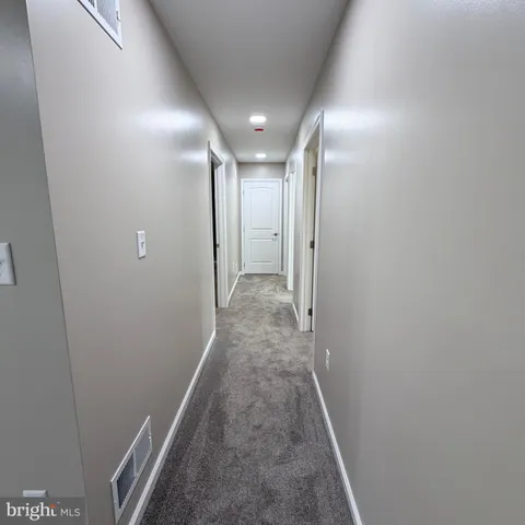 a bathroom with a double vanity sink a toilet and a mirror