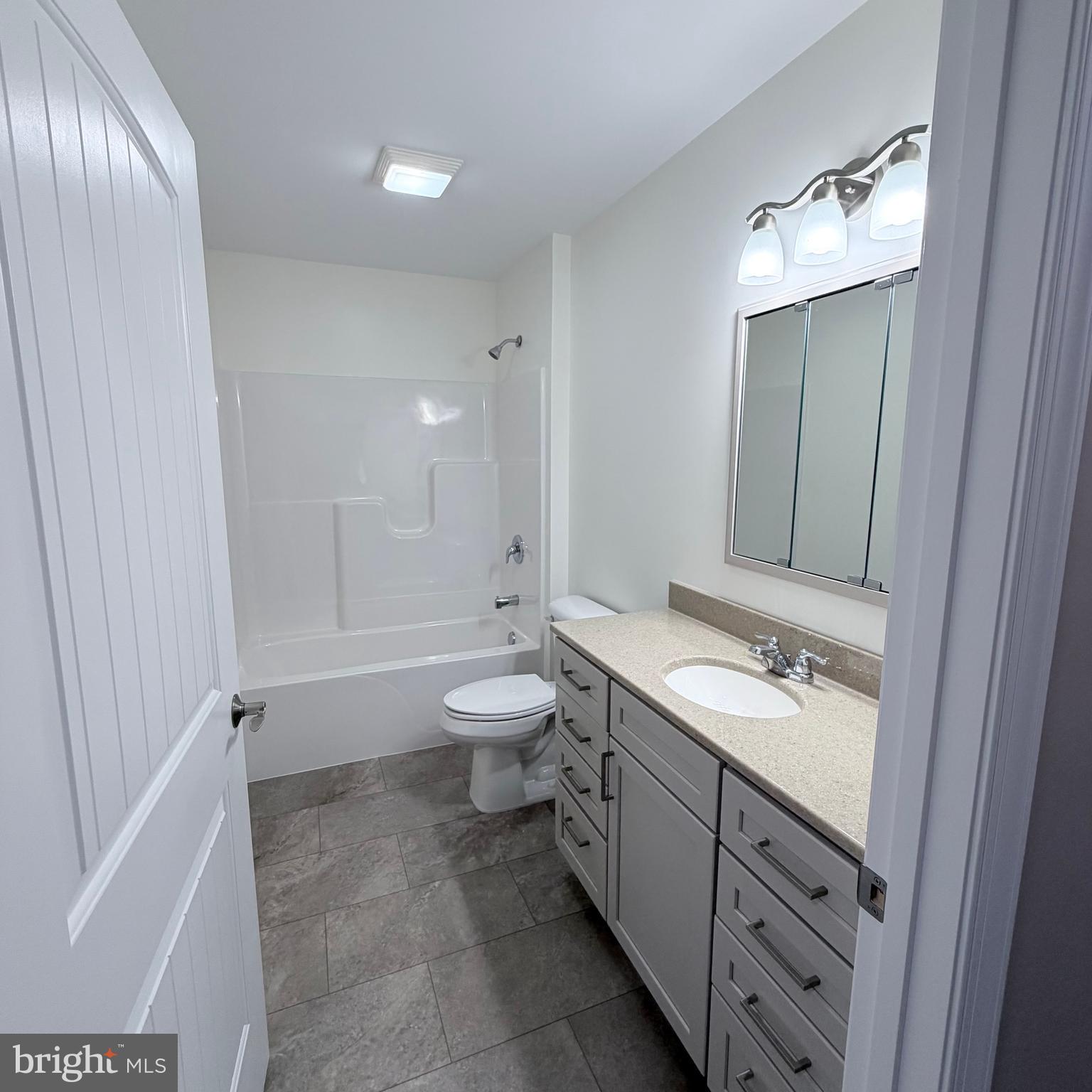 155 Buchanan Valley Road Orrtanna, PA 17353 - Photo 41 of 61 a spacious bathroom with a toilet sink and mirror