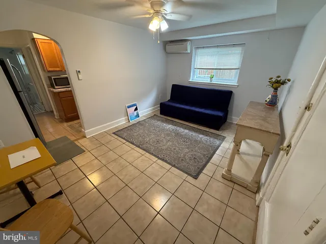 a view of a livingroom with furniture and natural light