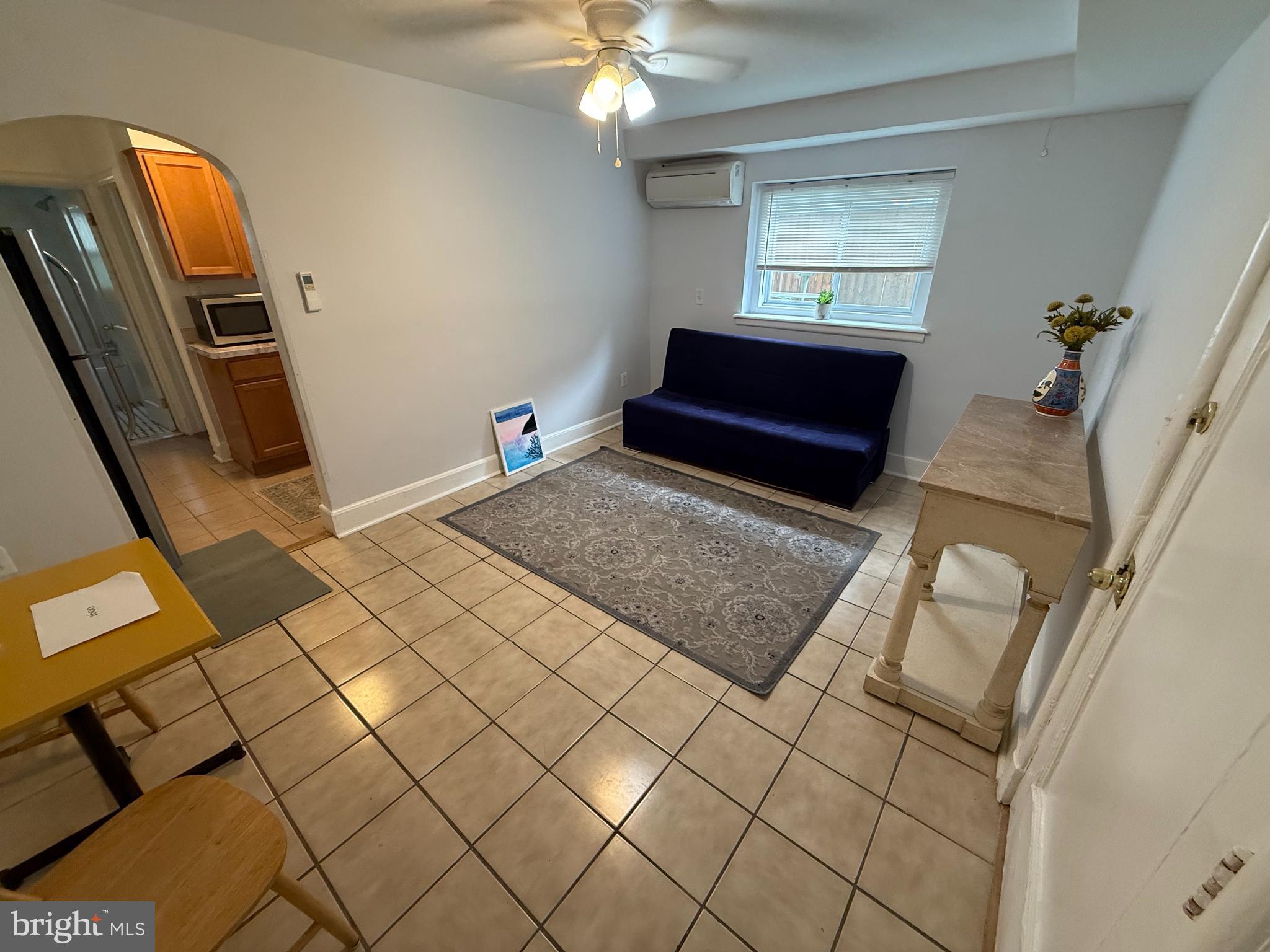 a view of a livingroom with furniture and natural light