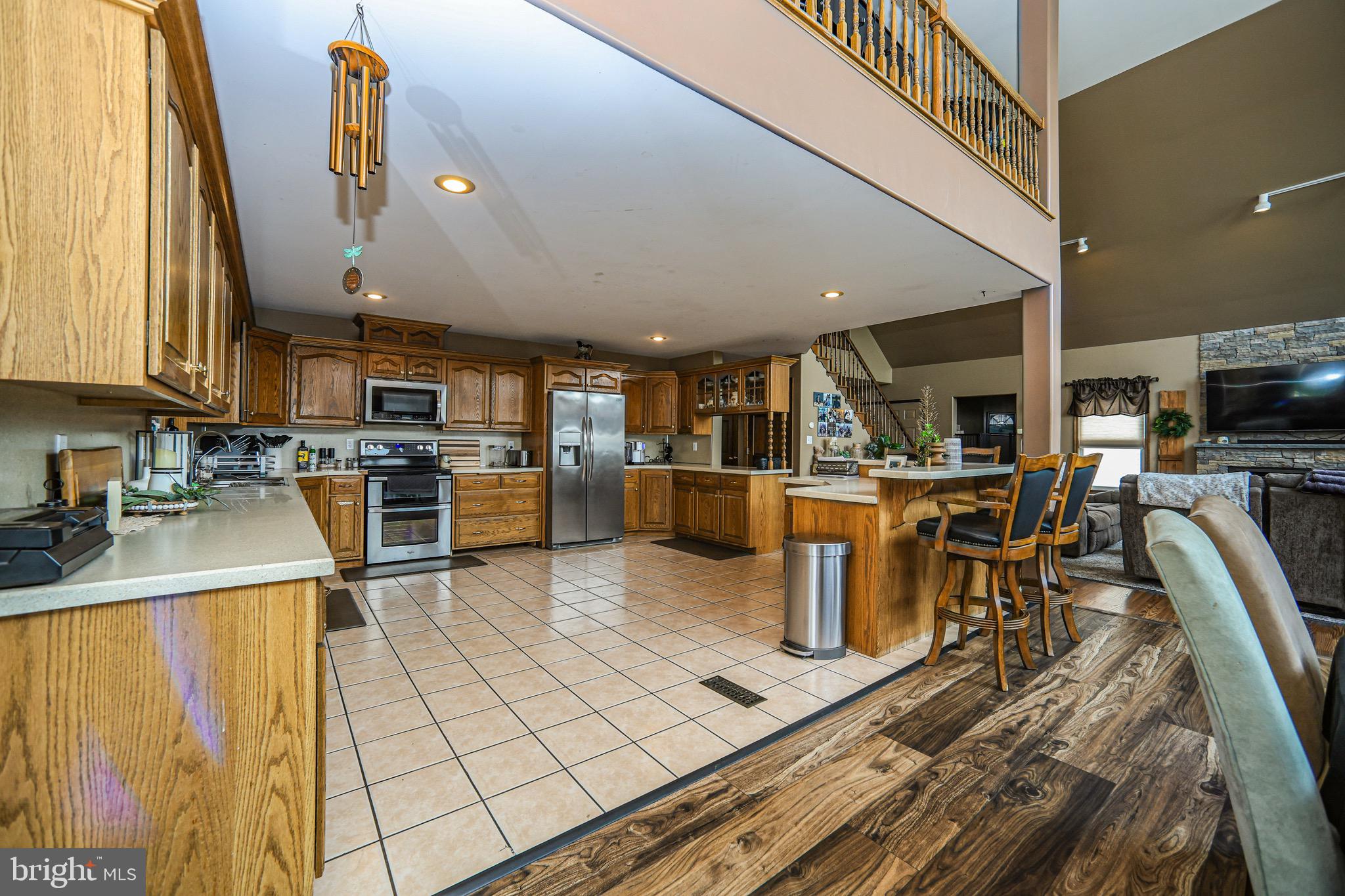 345 Kauffroth Road Narvon, PA 17555 - Photo 23 of 88 a kitchen with stainless steel appliances kitchen island granite countertop a table chairs and a refrigerator