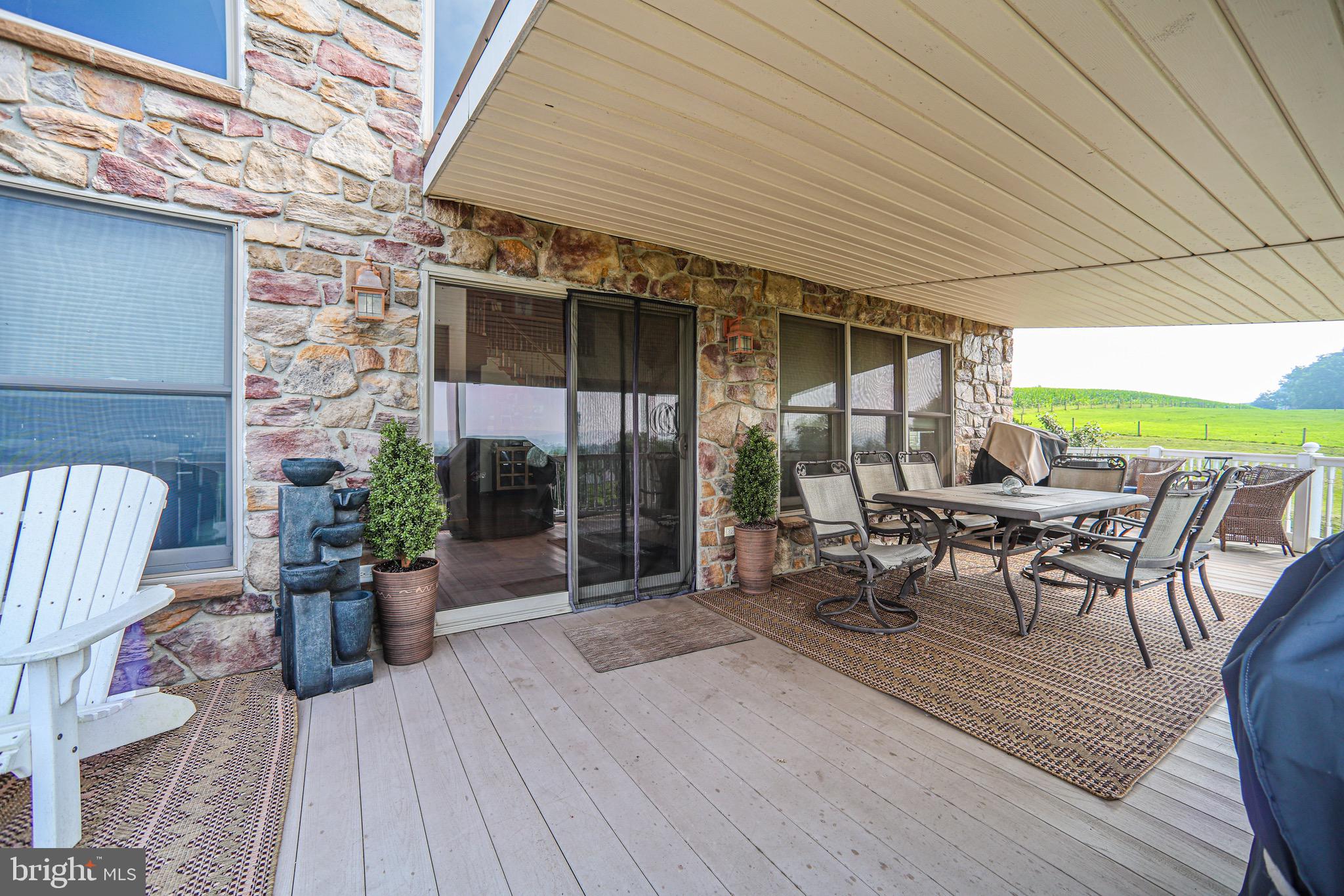 345 Kauffroth Road Narvon, PA 17555 - Photo 27 of 88 a view of a patio with table and chairs potted plants with wooden floor