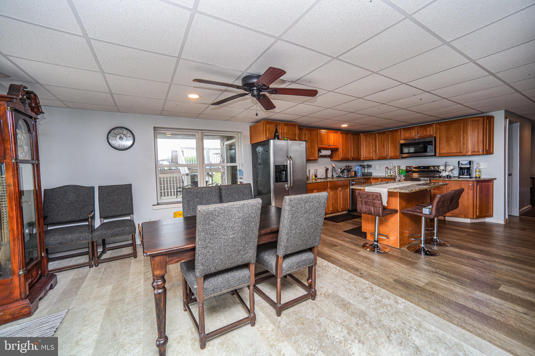 345 Kauffroth Road Narvon, PA 17555 - Photo 46 of 88 a dining room with stainless steel appliances kitchen island granite countertop a table chairs and a glass window