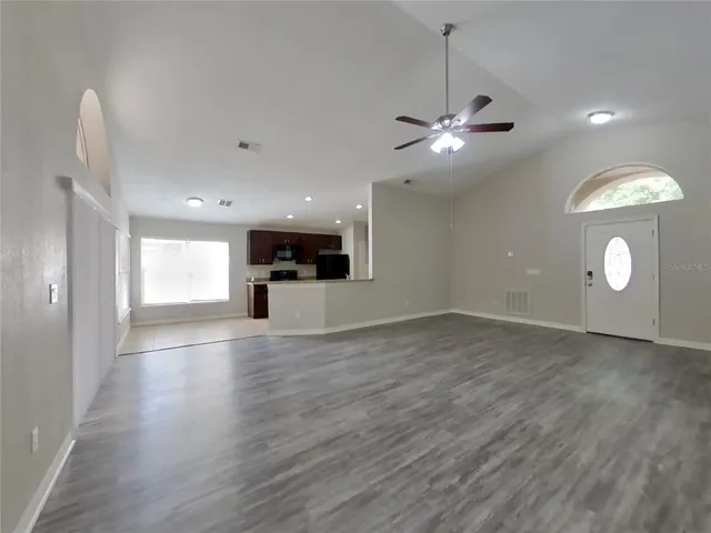 a view of a kitchen with a stove cabinets and wooden floor