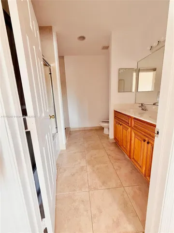 a bathroom with a sink a mirror and a shower